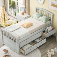 a child's bed with two drawers and a teddy bear sitting on the floor