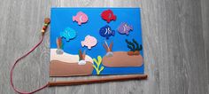 an ocean scene made out of felt and string