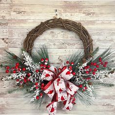 a christmas wreath with red and white decorations