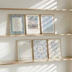 three wooden shelves with pictures and cards on them