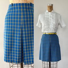 "An adorable mini skirt from the 1960s or early 1970s! Made from blue and yellow plaid polyester or polyester blend twill, the high waisted, a-line skirt features a front kick pleat and a mini length. Side zipper closure.  *shown styled with a shirt and belt that are not included. The shirt is available to purchase here: https://missdorothyvintage.etsy.com/listing/1628603688 Tag:  Material: polyester or polyester blend Estimated Size: Extra Small   Measurements: Waist: 24.5\"   Hip: 36\" Length: Retro Fitted Bottoms For School, Fitted Retro Bottoms For School, Retro Fitted School Bottoms, Retro Fitted Short Skirt, Retro Fitted Blue Mini Skirt, Retro Blue Fitted Skort, Retro Blue Knee-length Skirt, Retro Blue Mini Skort, Vintage Lined Mini Skirt