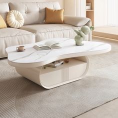 a white coffee table sitting on top of a carpeted floor next to a couch