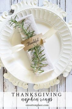 a white plate topped with napkins covered in greenery