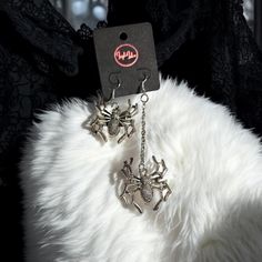 Step into the dark and glamorous world of Leigh Laloe Wicked Wonder with our Web of Lies Statement Earrings. These edgy and spooky earrings are the perfect addition to any outfit, adding a touch of mystery to your look. - Handmade with care - Material: Silver Plated Metal Alloy - Size: Earring 1: L: 9.5cm W: 2.5cm Earring 2: L: 4.5cm W: 2.5cm - Earring Type: Hook - Style: Goth - Perfect for: Casual Events, Dark and Edgy Events Edgy Earrings, Alternative Jewelry, Gothic Earrings, Spider Web, Statement Earrings, Wicked, Jewelry Earrings Dangle, Etsy Earrings, Dangle Drop Earrings