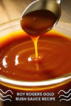 a spoon is pouring sauce into a glass bowl on a wooden table with the words, roy rogers gold rush sauce recipe