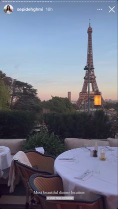 the eiffel tower is seen from an outdoor restaurant