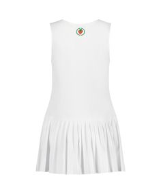 a women's white tennis dress with a green and red emblem on the chest