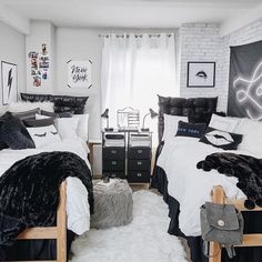 two beds with black and white comforters in a bedroom