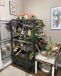 a bird cage filled with lots of birds inside of a living room next to a wall