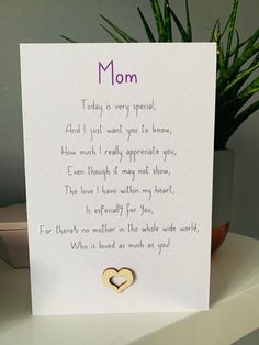 a mother's day card with two hearts attached to the front and back of it