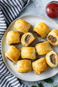 sausage rolls on a plate with ketchup