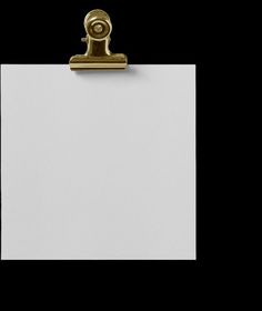 a white piece of paper with a golden clip on it's end and a black background