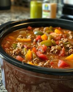 a close up of a stew in a crock pot on a counter top,