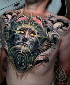 a man's chest with an artistic tattoo design on his body and face in the center