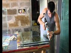 a man is sanding the glass in his house with an electric drill and glue