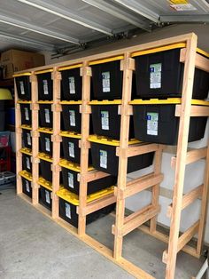 the shelves are filled with black and yellow bins