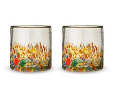 two glass vases sitting side by side on top of each other with colorful designs