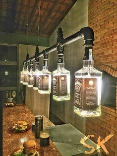 several bottles are hanging from the ceiling above a counter