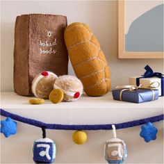 two stuffed animals sitting on top of a shelf next to a bag and gift box