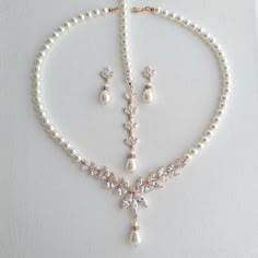 a necklace and earring set with pearls