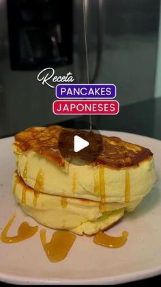 pancakes on a plate with syrup being drizzled over them and the words pancakes japanese