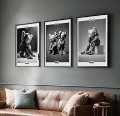 three black and white pictures hang on the wall above a couch