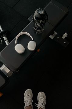 a pair of white headphones sitting on top of a black table