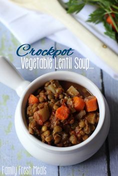 a close up of a bowl of food with carrots and lentils in it