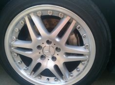 the front wheel of a car with chrome spokes