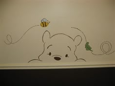 winnie the pooh wall decal in a child's room with a bee and honey