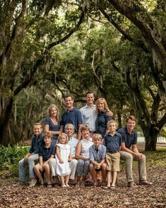 a family posing for a photo under the trees