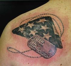 a man's chest with an american flag and tags on it