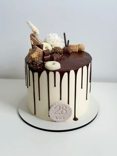 a chocolate cake with white icing and decorations