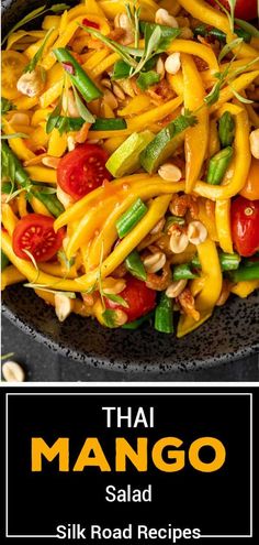 thai mango salad with cashews and tomatoes in a black bowl