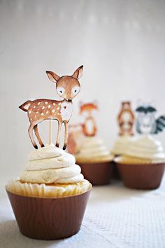 some cupcakes with frosting on top of them are decorated like deers