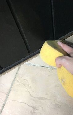 a person is using a sponge to clean the floor