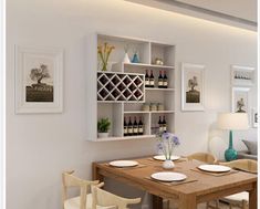 a dining room table and chairs with wine bottles on the shelves above it, in front of a couch