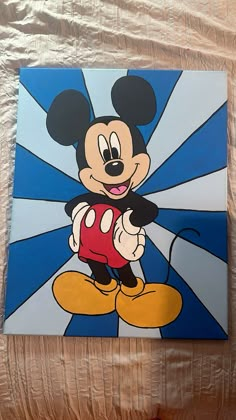 a painting of mickey mouse on a bed