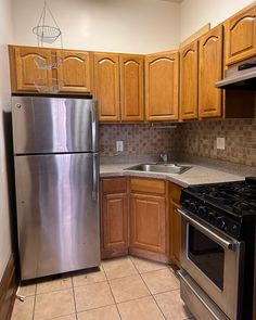 a kitchen with stainless steel appliances and wooden cabinets