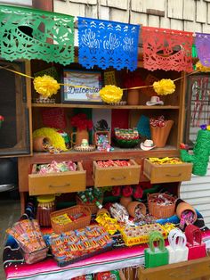 an outdoor market with lots of different items on display and decorations hanging from the ceiling