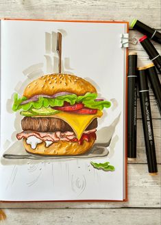 a drawing of a hamburger with cheese and lettuce on it next to markers