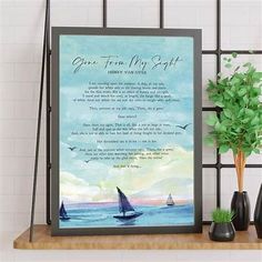 a framed poem on a shelf next to a potted plant and vase with plants