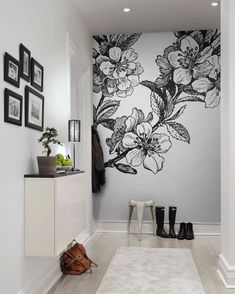 a white hallway with black and white flowers on the wall