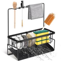 the dish rack is holding dishes and cleaning utensils, including a brush, sponges, and other kitchen items