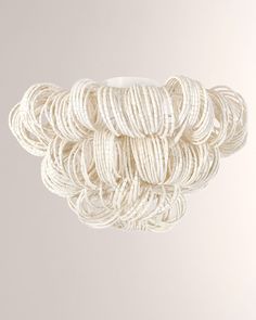 several balls of white yarn hanging from the ceiling