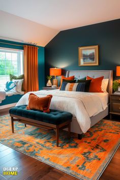 a bedroom decorated in teal and orange with a large bed on top of a rug