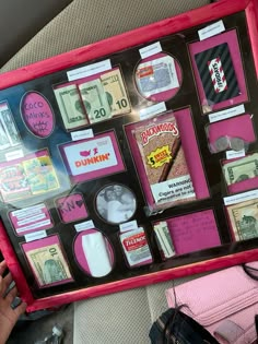 a pink and black framed display with money on it's back end, in the backseat of a car