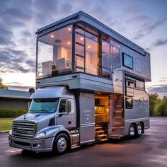 a large truck with a glass cabin on the top is parked in a parking lot