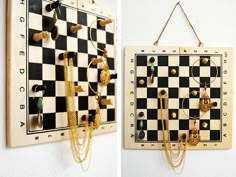 two pieces of jewelry hang on the wall next to a chess board and necklaces