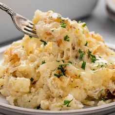 a white plate topped with mashed potatoes covered in gravy